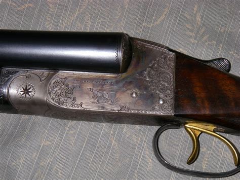 SN# 99177. . Ithaca double barrel with dog engraving